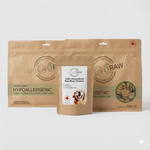 Two Artisan Raw Hypoallergenic freeze-dried dog food bags and a bag of Bison Tendons treats displayed together on a plain background.