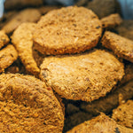 Hypoallergenic freeze-dried meal in round, brown patties stacked together.