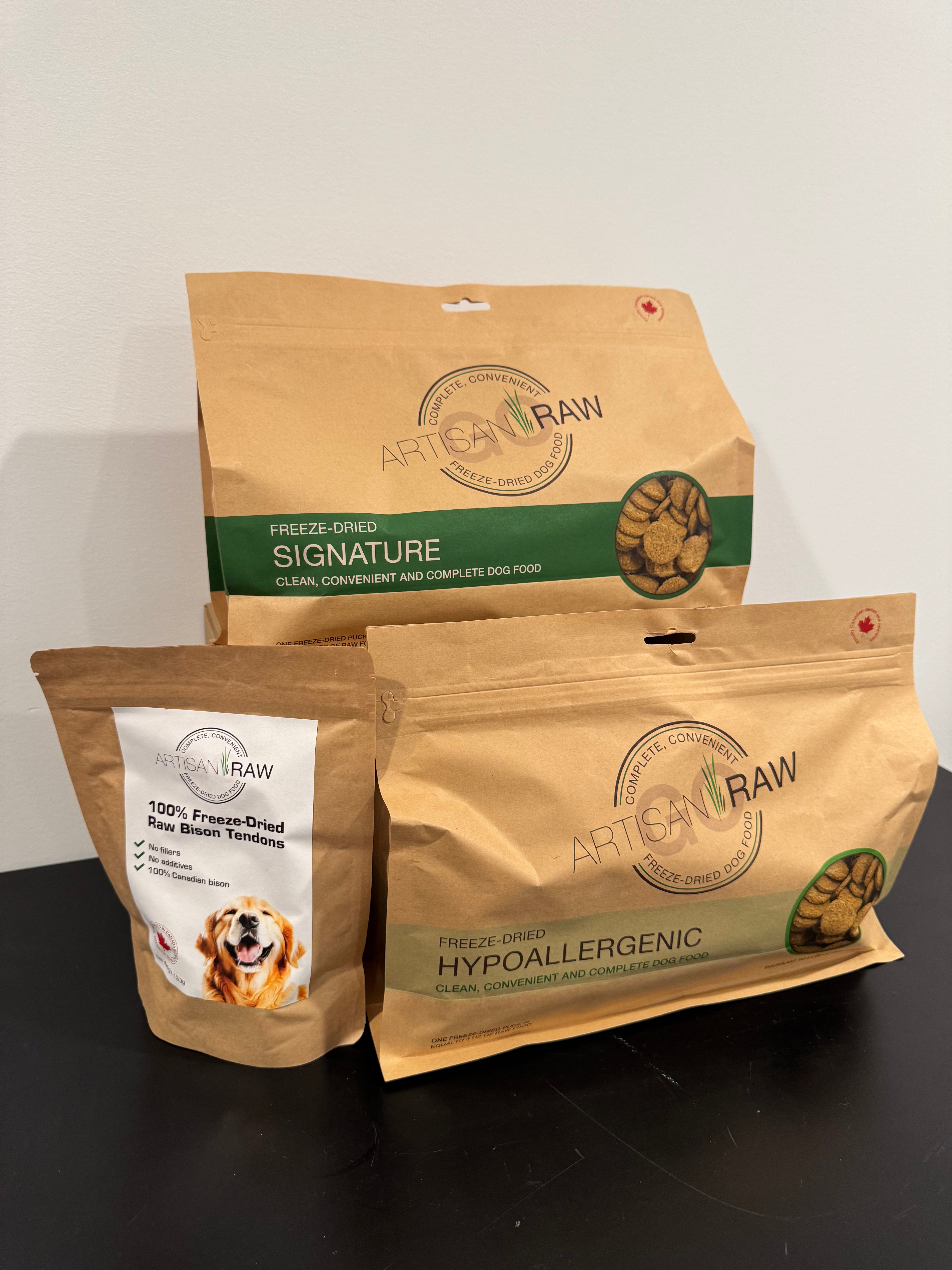 Artisan Raw GO! sampler box with three freeze-dried dog food packages: Signature, Hypoallergenic, and 100% Freeze-Dried.