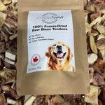 Artisan Raw 100% Freeze-Dried Raw Bison Tendons treat bag, featuring a golden retriever on the label, resting on a bed of dried bison tendon pieces.