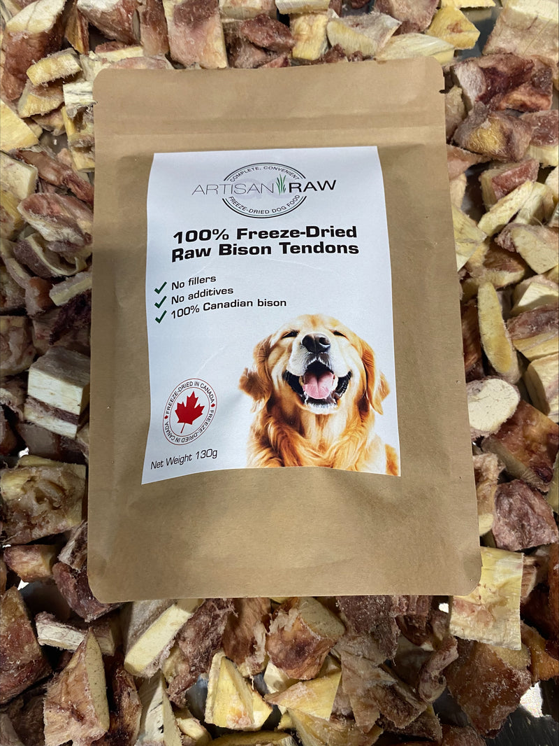 Artisan Raw 100% Freeze-Dried Raw Bison Tendons treat bag, featuring a golden retriever on the label, resting on a bed of dried bison tendon pieces.